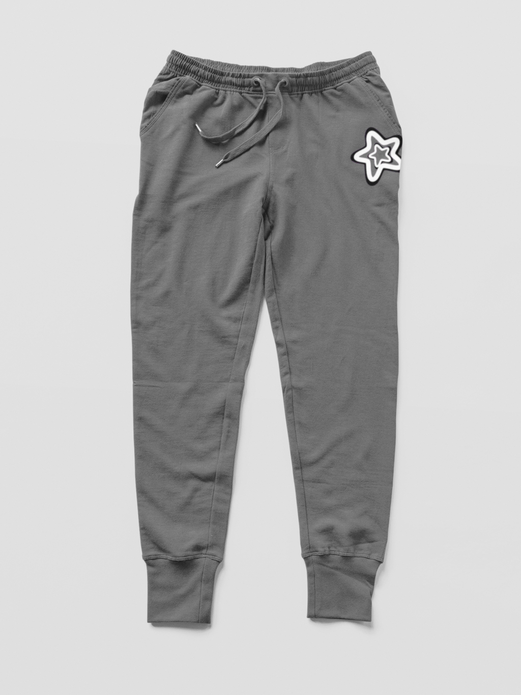 Gray jogger pants with a star design on a light gray background